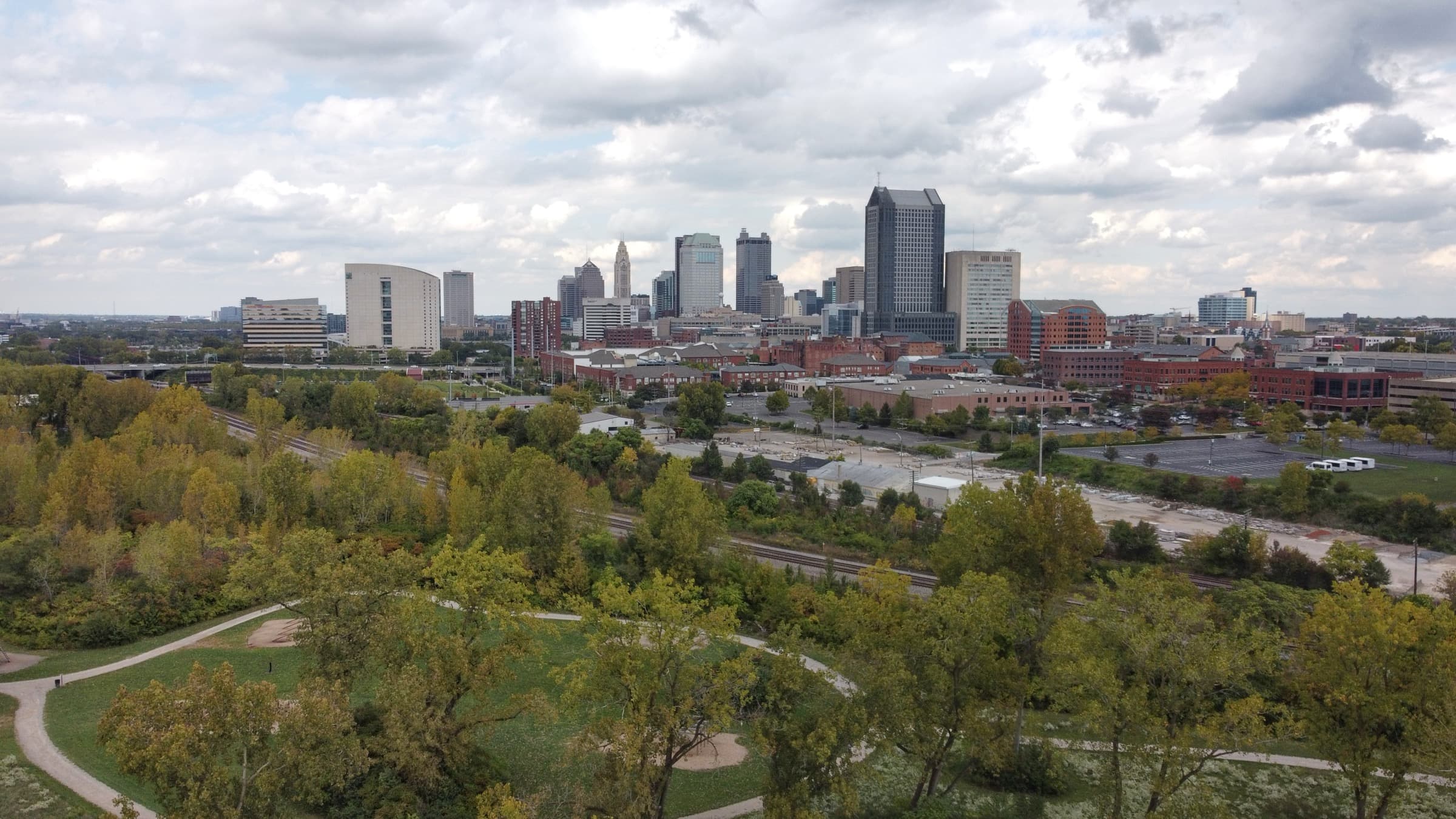 The Columbus skyline rising beyond leafy neighborhoods and parkland