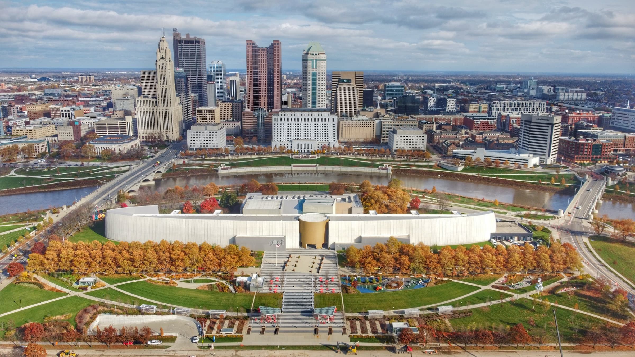 Aerial view of the downtown Columbus skyline over the Scioto River, COSI, and the riverfront parks